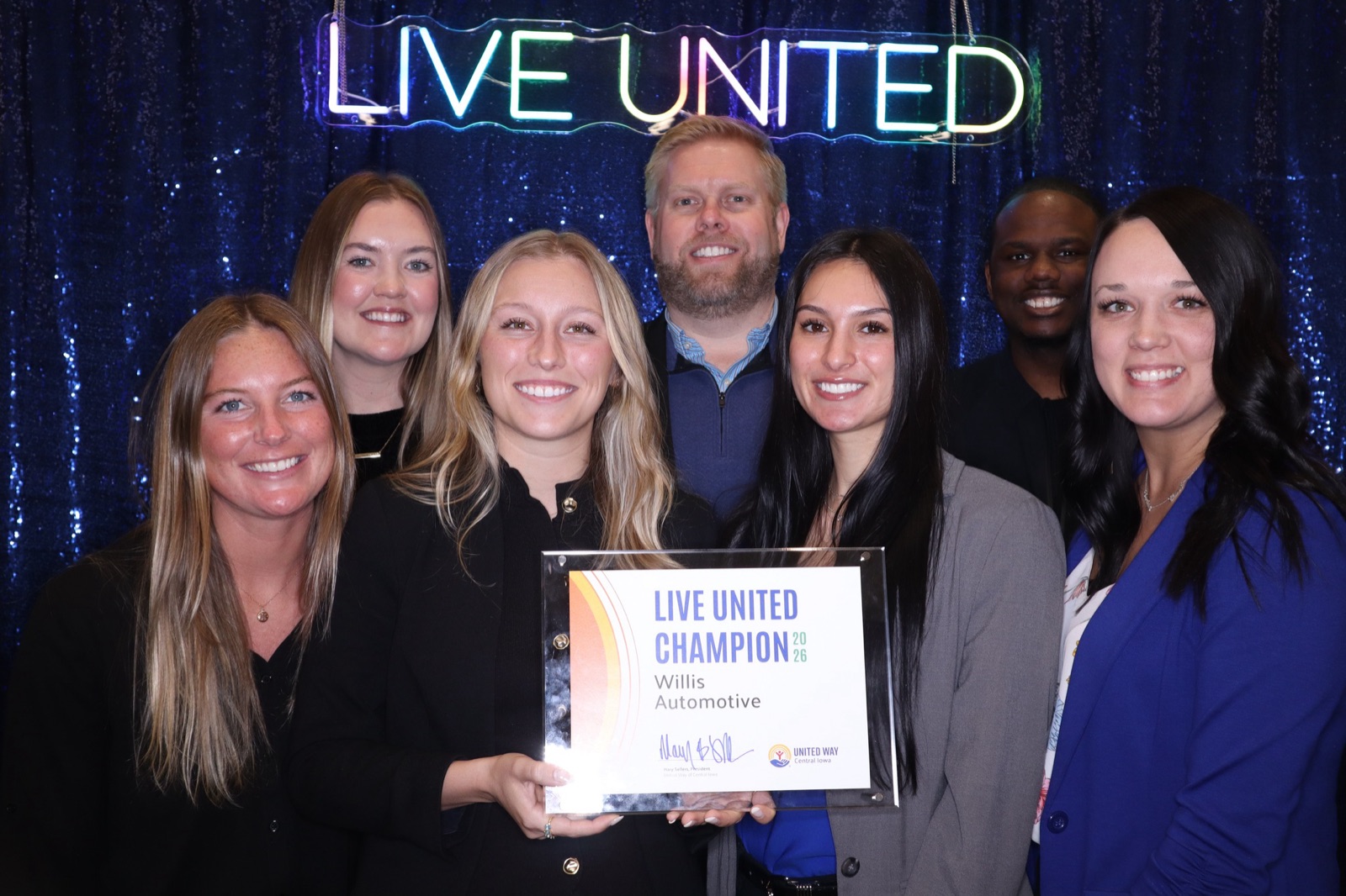 Willis Automotive team members holding the Live United Champion 2026 award from United Way of Central Iowa.