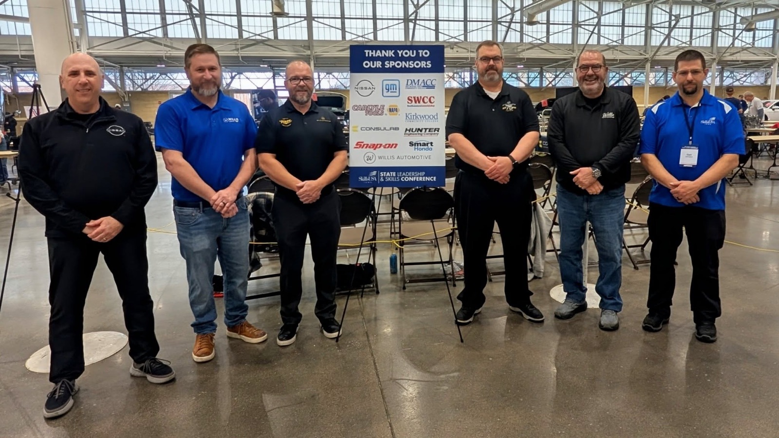 Willis Automotive team members at the SkillsUSA Iowa State Leadership & Skills Conference sponsor wall.
